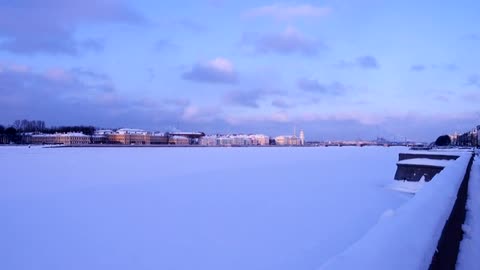 river covered in snow and the city