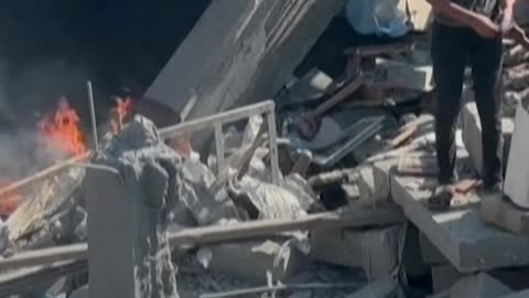 Palestinians inspect damage at Bureij camp following Israeli strike