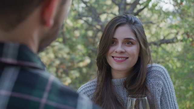 girl drinking a glass of wine with a man