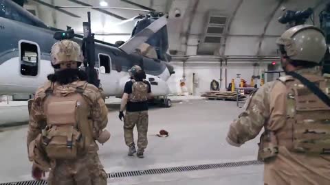 Taliban forces in U.S. gear inspecting CH-46E Sea Knights choppers