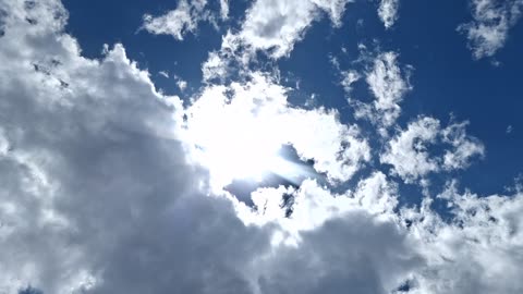 Created material and not that high up in the atmosphere. Different colors. White/Blue sun.