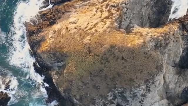 brown rock formation on body of water during daytime video