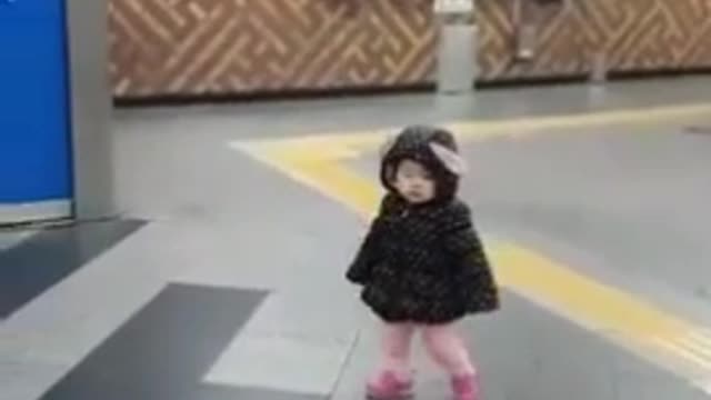 Baby walking alone subway station