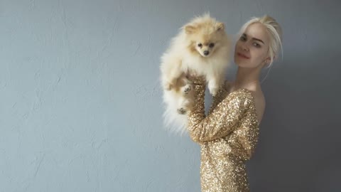 Beautiful Blonde Woman With Her Spitz Isolated On Grey