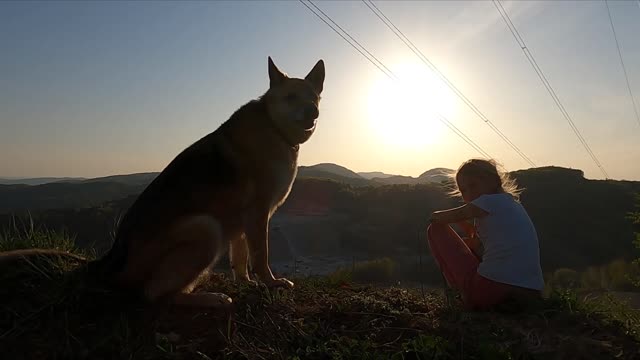 A Girl With Her Pet Dog Enjoying Nature