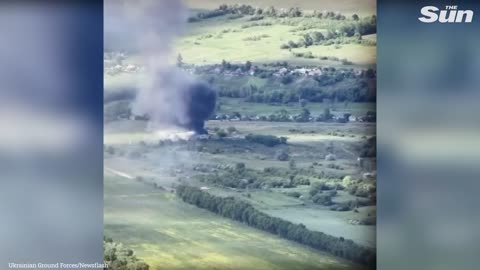 Ukrainian soldiers shell a Russian base that erupts into flames