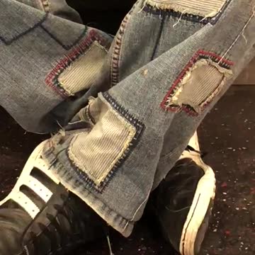 Man wears jeans with jean patches