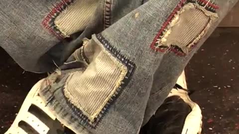 Man wears jeans with jean patches