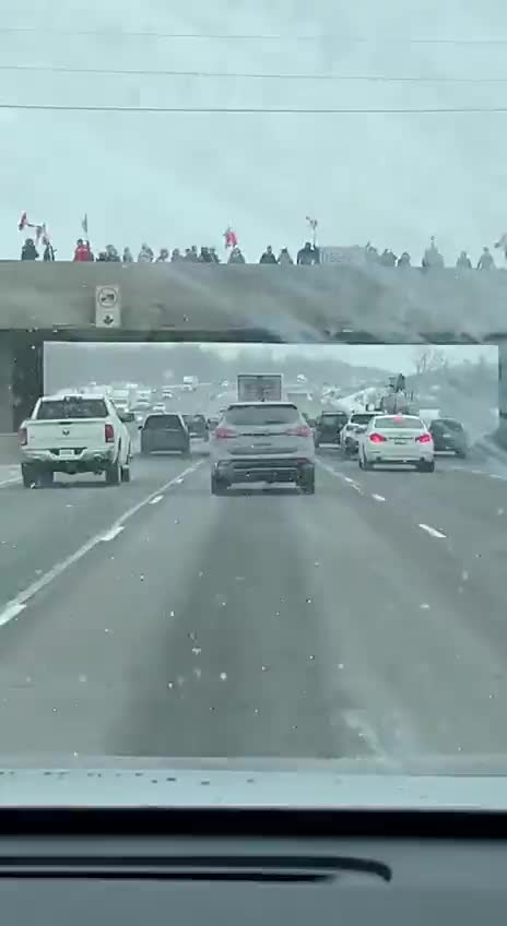 Chris from PoliceOnGuard on the way to Ottawa. Overpasses are packed with Canadians cheering.