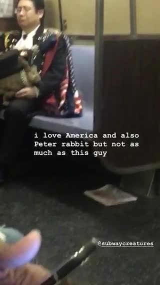 Man in full uniform carrying rabbit on his lap