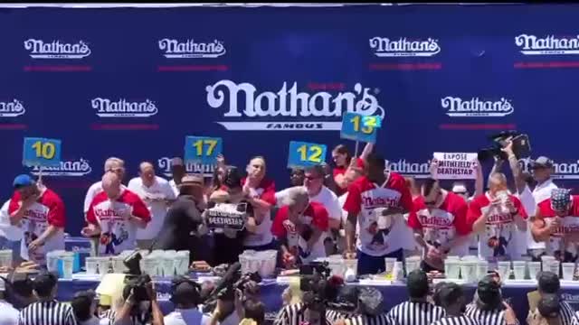 Joey Chestnut slams down a protester at a hot dog eating contest