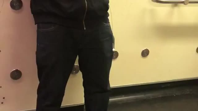 Guy listens to music out loud on train when he has earphones in his pocket