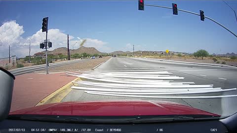 Truck Loses its Load of Pipes