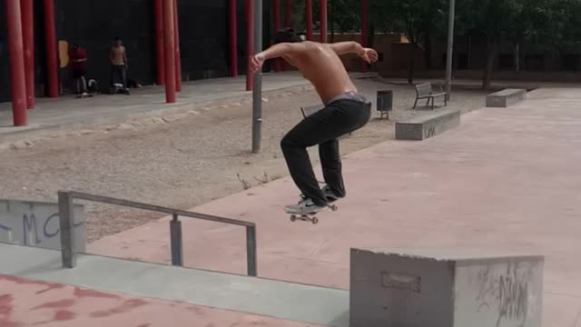 Black bucket hat does splits on skateboard