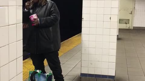 Guy eats out of tub with spoon in subway