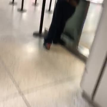 Man chilling at a train station with his pants half down, buttcheeks showing