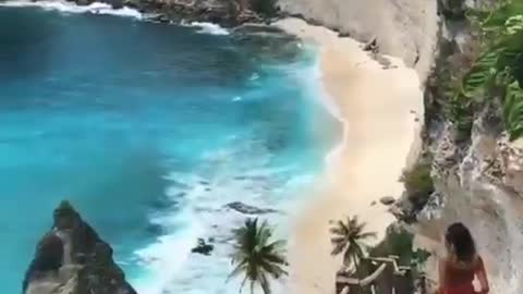 Girl Walking Down The Stairs Towards A Paradise Beach