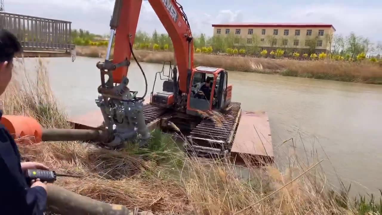 Grab Bucket Attachment Mounted on Caterpillar 307 Amphibious Excavator