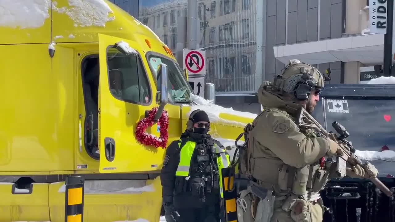 Wait for the end, Canadian police officer aiming his gun inside Freedom Convoy Truckers Car