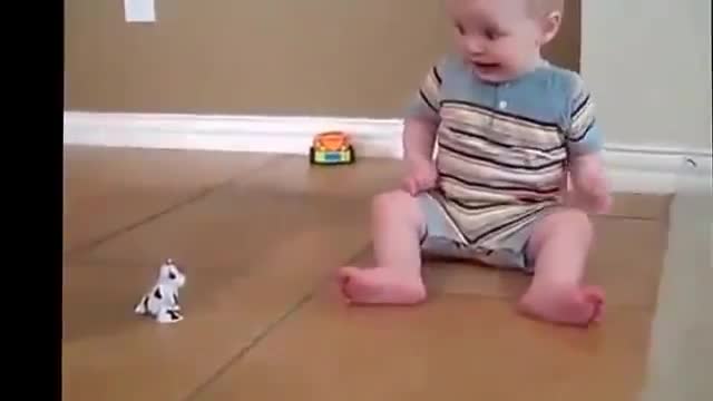 Funny cute baby scared by toy cow