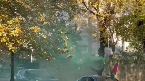 Anti-Israel protesters setting off smoke bombs in front of a synagogue in London.