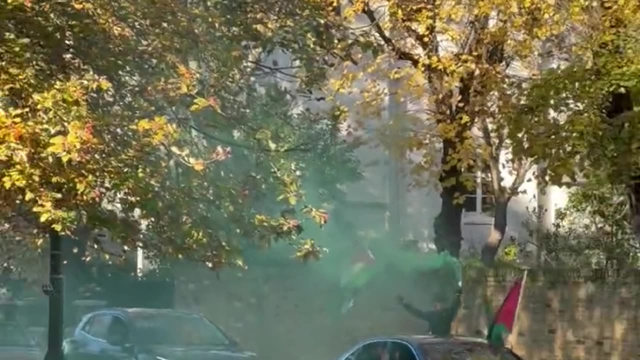 Anti-Israel protesters setting off smoke bombs in front of a synagogue in London.