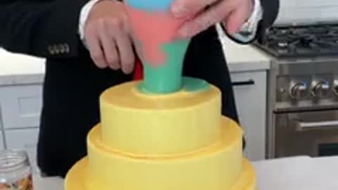 When he lifts the cup of icing over the Wedding Cake...