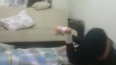 Girl back flips on mattress on floor