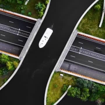 Drone Footage: 'Disappearing' bridge carries boats across Dutch motorway