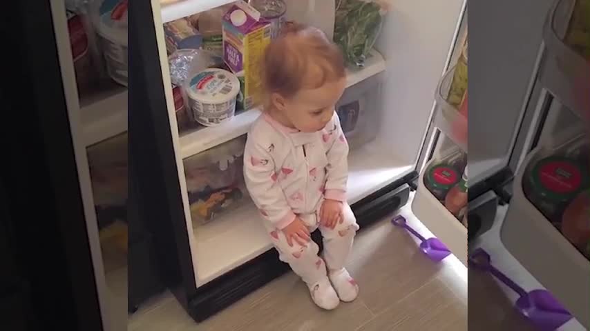 This baby sees the refrigerator as home of comfort