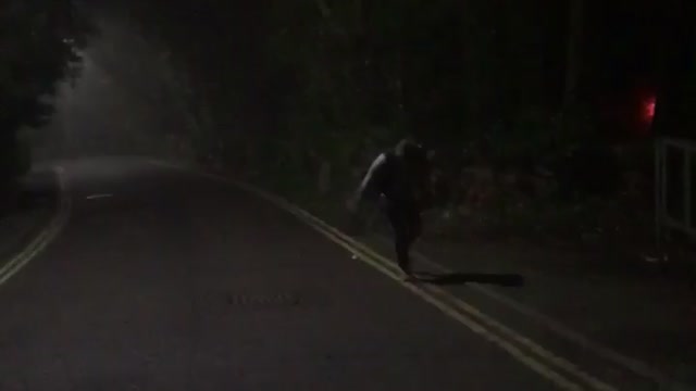 Guy throws sign at car
