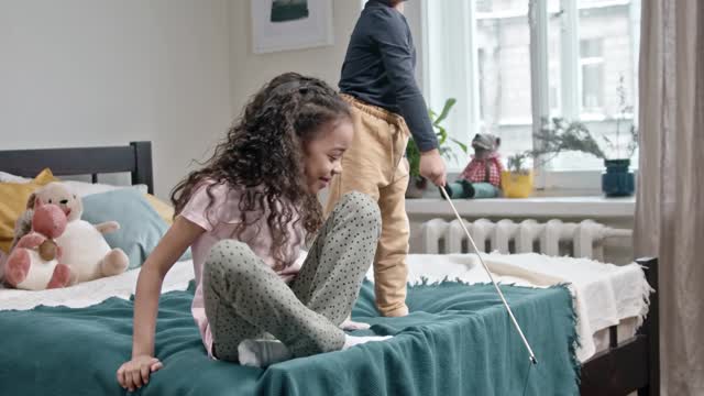 Kids Playing Catch The Bait With Their Cat