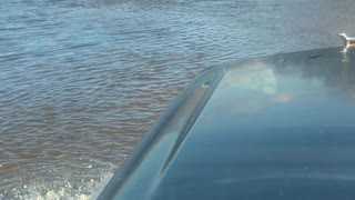 Truck Fords Through Flooded Roadway