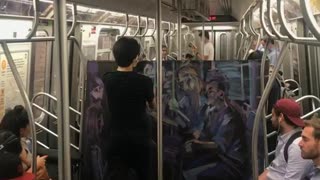 Man painting purple mural on subway train