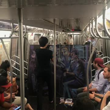Man painting purple mural on subway train