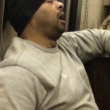 Sleeping beanie guy with hand in pocket snores on subway
