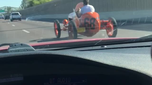 Passing by a 1930’s racecar on a busy freeway