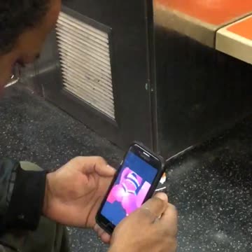 Guy watching butt twerking videos on phone subway