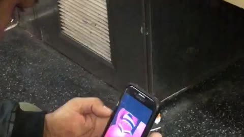 Guy watching butt twerking videos on phone subway