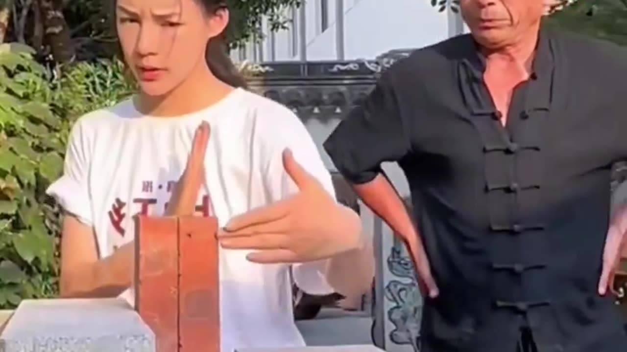 A young girl studies kung fu and learns to break bricks with her fragile hands