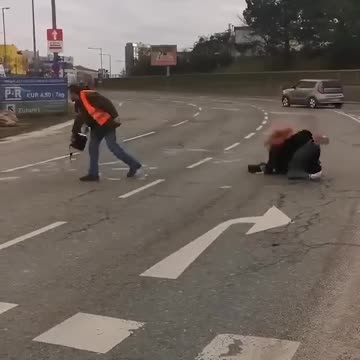 Hilarious moment Just Stop Oil protester slips in liquid she is pouring onto road.mp4