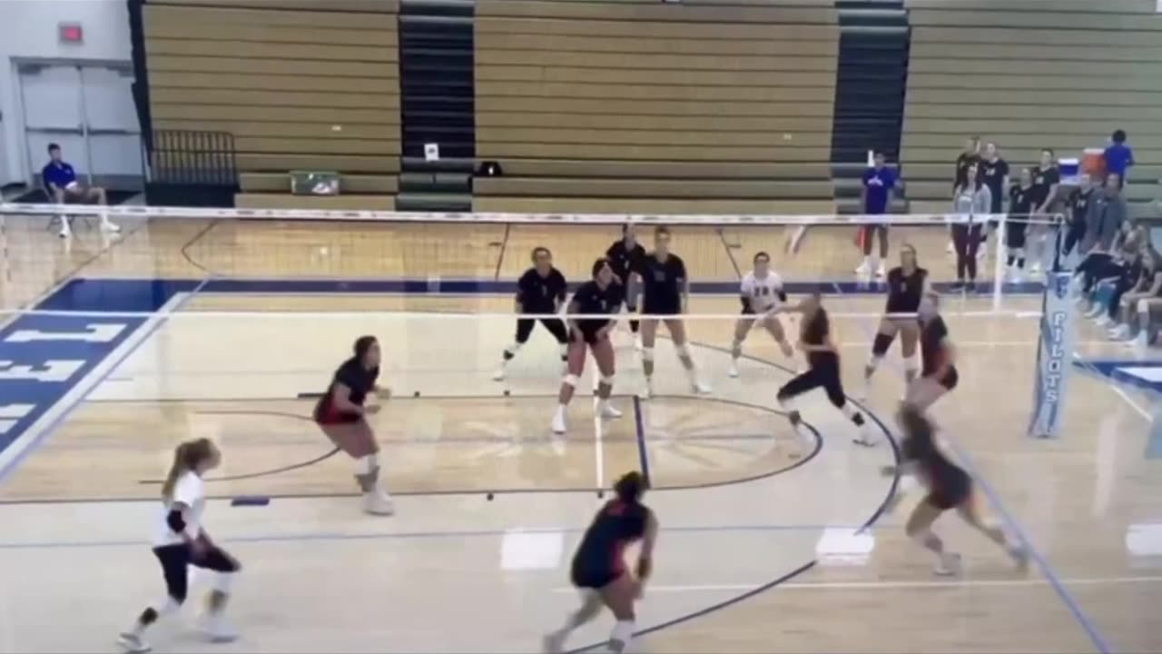 Volleyball player rolling to get out of the way