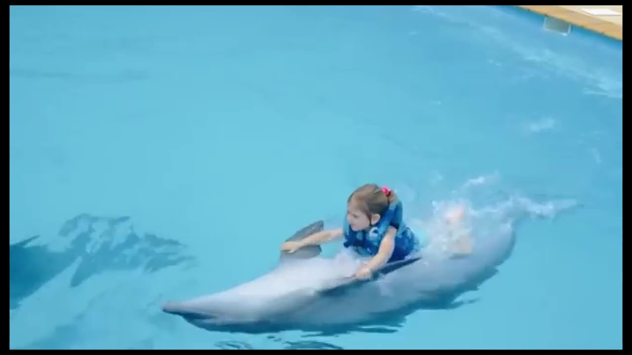 Mother and daughter display with trained dolphin.