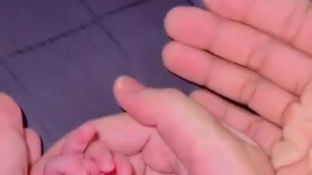 Newborn baby showing middle finger while making emotional video