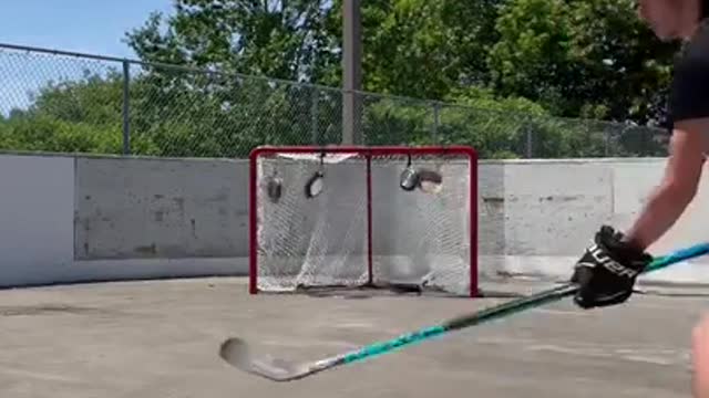 Guy Shows off Amazing Ice Hockey Skills by Hitting Pans Hanging on Goalpost With Pucks