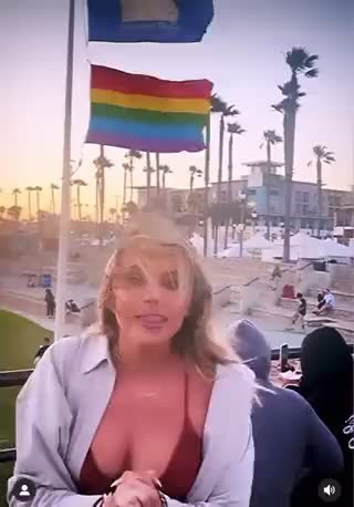 Alison Steinberg OAN Contributor is raging at Huntington Beach flying a Pride flag