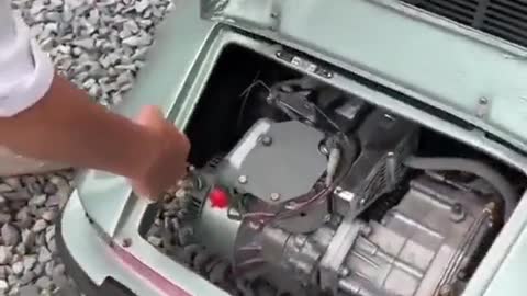 A small driver drives a convertible car to repair the car.