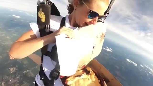 Eat Pizza on a paragliding