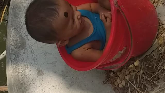 The baby didn’t want to get up from the bucket he was joking.