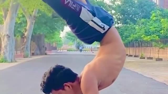 Contortionist Shows Amazing Balancing Trick While Doing Handstand